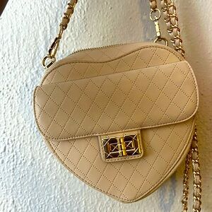 Pretty cute little bag in the shape of a heart, cream colour. Never worn and new